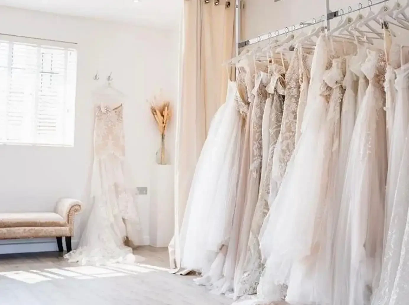 image shows a rack of wedding gowns