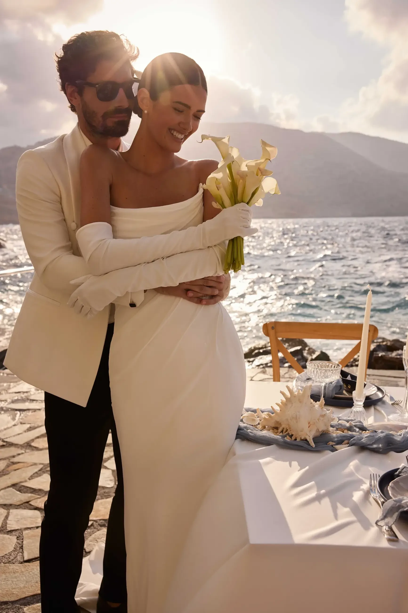 model is wearing a strapless minimalist bridal gown with gloves